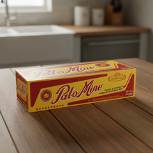 Load image into Gallery viewer, A box of Palo-Mine food and peanuts snack mix sits on a wooden table in a blurred kitchen setting.